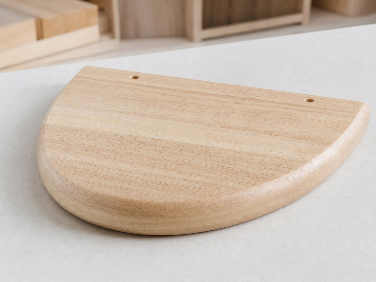 A smoothly rounded pale rubberwood component with visible natural grain and a matte furniture finish.