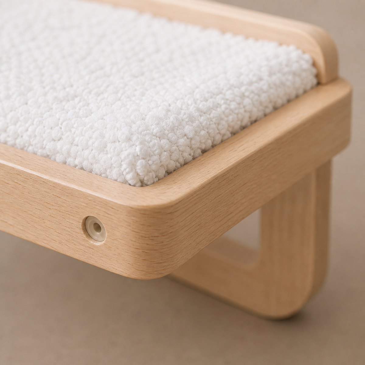 Rounded pale wood perimeter rail and clean fabric wrap