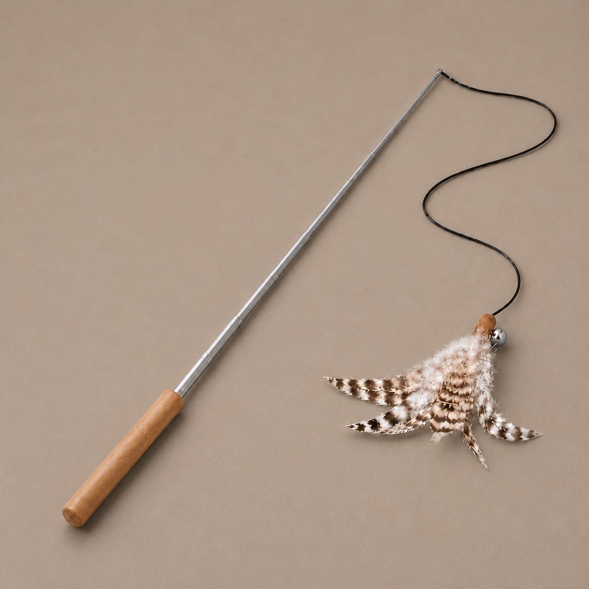 Retractable Feather Wand on a neutral warm mushroom taupe studio background