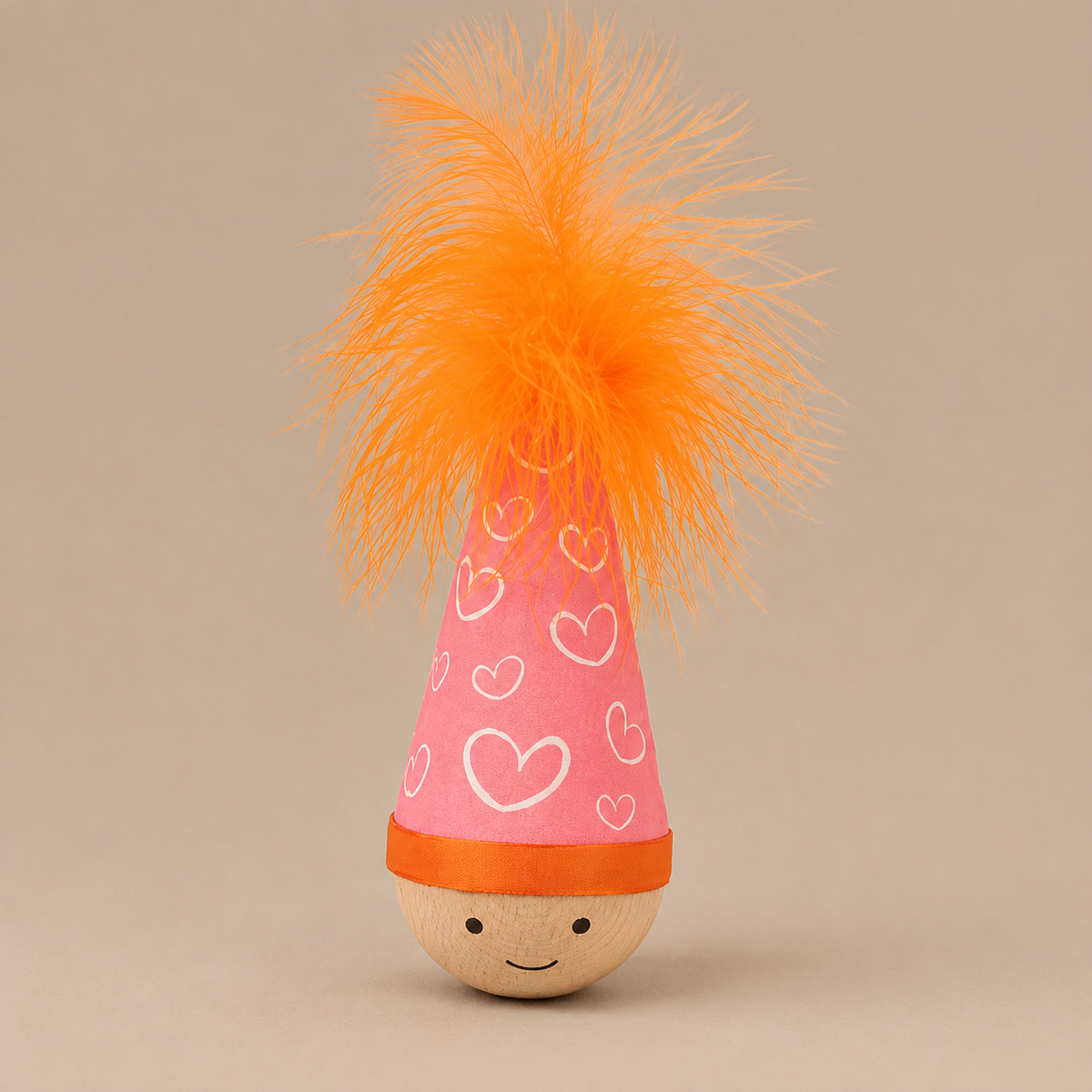 Girl (Pink) Wobble Toy, one item with a heart-patterned pink hat and orange feather.