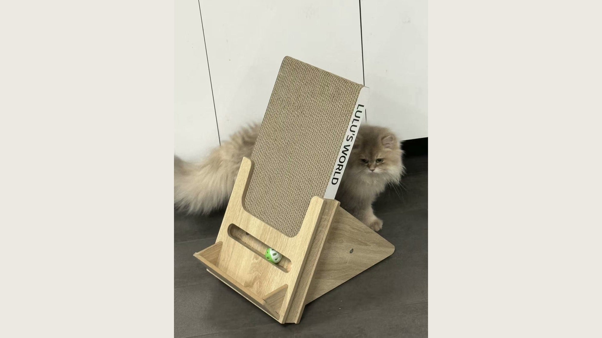 A cat using the inclined scratcher in a quiet living room.
